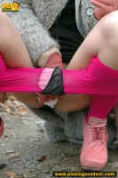 MILF brunette pissing on concrete lookout