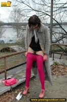 MILF brunette pissing on concrete lookout