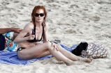 Beautiful Marg Helgenberger wearing black bikini.