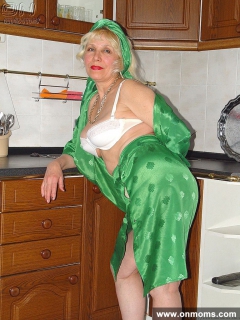 Mature housewife undressing in the kitchen - N