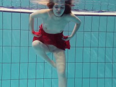 Red Dressed teen swimming with her eyes opened